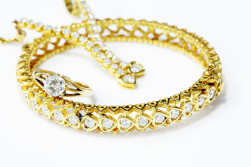 Gold jewelry on white background.