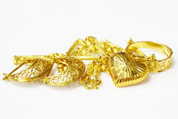 Gold jewelry on white background.