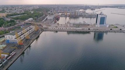 Aerial of a seaport with long breakwaves, yachts and Potemkin Stairs in Odessa