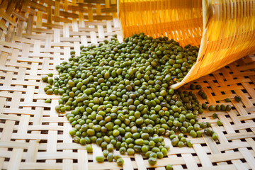 Mung beans or green beans on bamboo threshing basket with mung beans seed