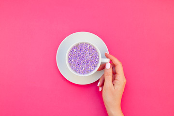 Cup of beautiful lilac flowers infused water