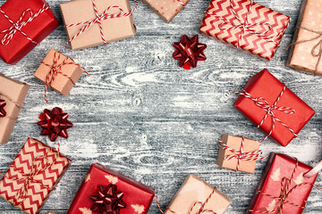 Frame of Christmas gift boxes with copy space on grey wooden background. © WindyNight