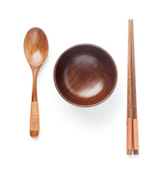 Wooden spoon and chopsticks with bowl isolated on white background. Top view.