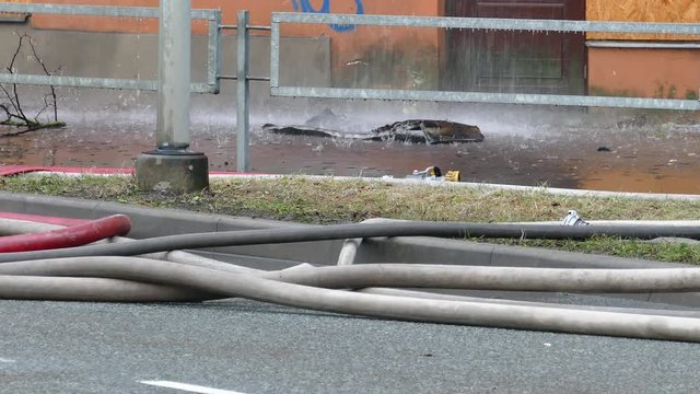 Close-up of firehose on street during fire extinguishing event