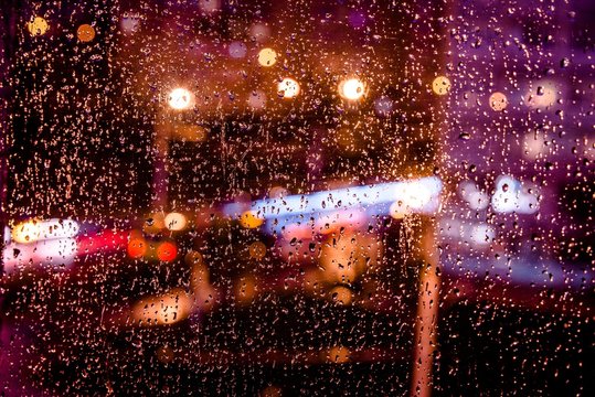 Night city lights in the window in the rain © licvin