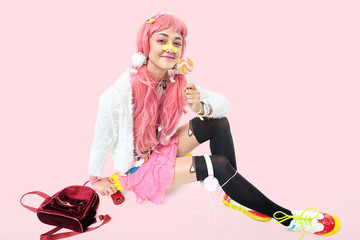 A beautiful Asian teen girl in pink headphones, dressed in anime or kawaii style