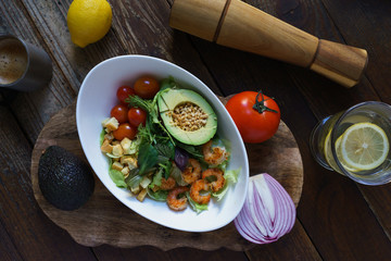 avocado shrimp salad on wooden board