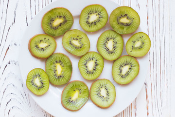 Fototapeta na wymiar Kiwi fruits on white wooden table