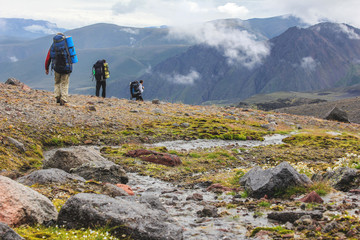 Hikers on a mountain trail. Ascent to the highest point of Europa