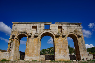 Fototapeta na wymiar Arch of Mettius Modestus in ancient Lycian city Patara (Pttra). Kas, Antalya, Turkey.