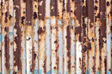 Old. rusty fence of metal sheets.