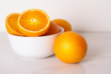 oranges on a white plate on a white plate close-up.
