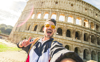 Happy tourist takina selfie at the Colosseum in Rome, Italy