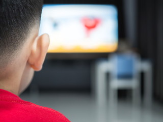 A boy watching a television, Tv effect on children