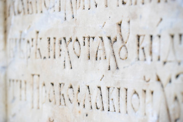 Fragment of the Cyrillic Old Slavic letter on the wall in the temple. Selected focus