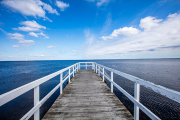Fototapeta na wymiar wooden pier on the blue sea