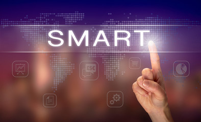 A hand selecting a SMART business concept on a clear screen with a colorful blurred background.
