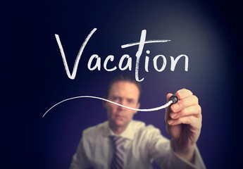A businessman writing a Vacation concept with a white pen on a clear screen.