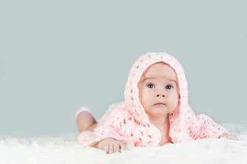 Portrait of a crawling baby on the bed in her room