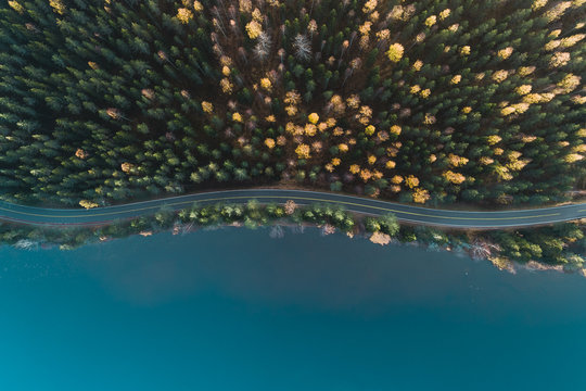 Above view of a road by lake and autumn forest, Finland