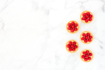 Raspberry Tartlets with Lemon Cream on White Marble