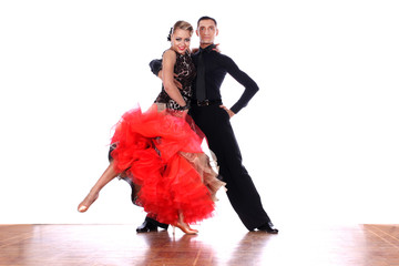 Latino dancers in ballroom against white background