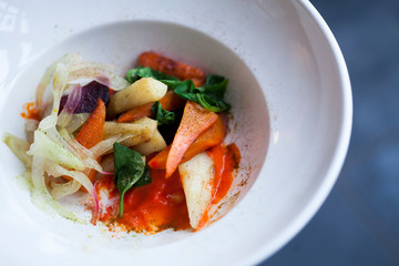 vegetables carrots cabbage beets onion greens in a white plate close shot
