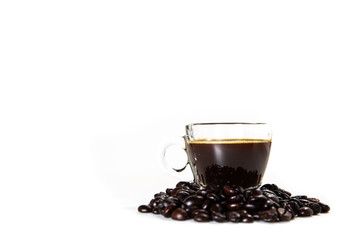 The glass mug of coffee and coffee bean