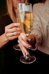 Hands holding the glasses of champagne making a toast