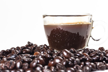 The glass mug of coffee and coffee bean