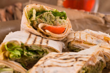Pieces of vegetarian falafel roll on a wicker tray. Serving dishes.. Traditional Middle Eastern snack. Fastfood.
