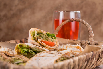 Pieces of vegetarian falafel roll on a wicker tray. Serving dishes.. Traditional Middle Eastern snack. Fastfood.