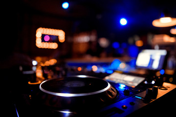 Fototapeta na wymiar DJ sound equipment at nightclubs and music festivals, EDM, future house music and so on. Parties concept, sound technique. DJ playing on the best, famous CD players.