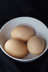 Brown eggs in a white cup ready to eat