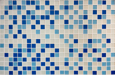 Texture of small squares of mosaic in white and navy ceramic tiles.