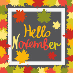 Hello November. Autumn background with maple leaves, drawn letters and white   frame.