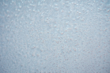 The patterns made by the frost on the window. Frosty winter background photo