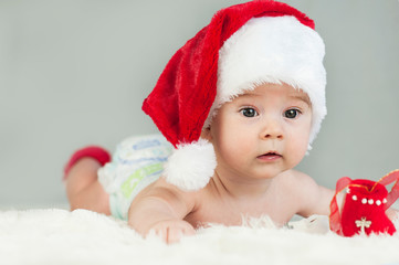 Happy newborn girl in santa hat. New Year,Christmas