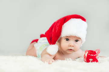 Happy newborn girl in santa hat. New Year,Christmas