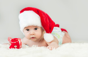 Happy newborn girl in santa hat. New Year,Christmas