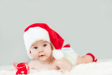 Happy newborn girl in santa hat. New Year,Christmas