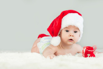 Happy newborn girl in santa hat. New Year,Christmas