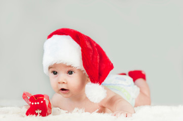Happy newborn girl in santa hat. New Year,Christmas
