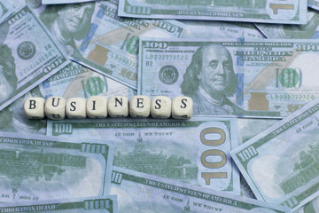 Business word on wood brick  background banknote.
