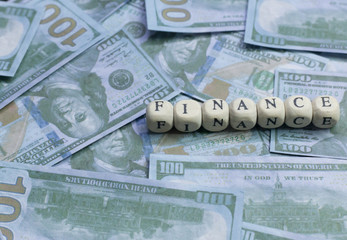 Finance word on wood brick  background banknote.