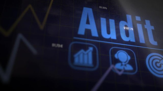 Audit business concept on a flashing computer monitor with moving graphs and data.