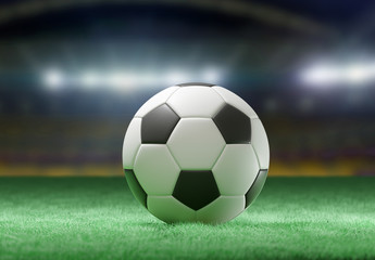 Fototapeta na wymiar Football ball on the field of a stadium - 3d rendering