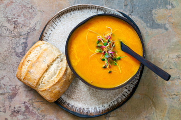 Carrot soup with the topping of green sprouts