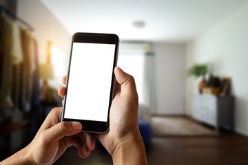 A woman hand holding smart phone device in the coffee shop or cafe background.
