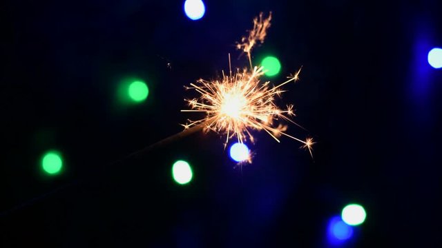 Video HD with burning sparkler or bengal light in the silvester holiday night